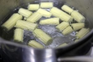 blanching baby corn in boiling water