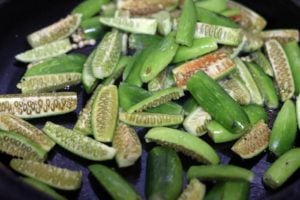 sliced ivy gourd added to the tempering for dondakaya fry