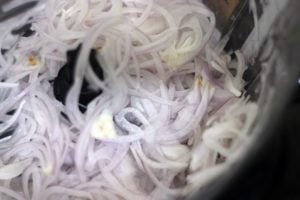 sliced onions in a food processor jar