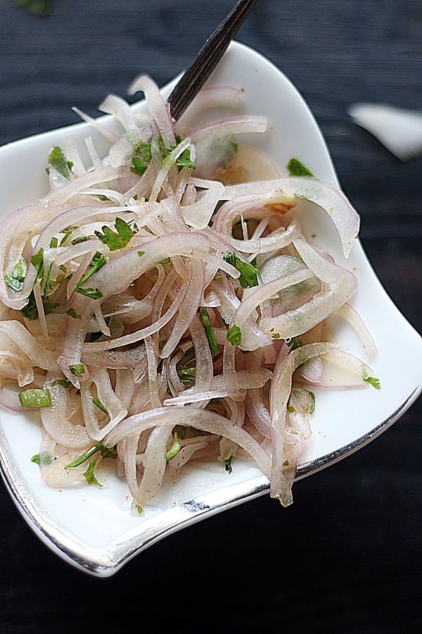 Indian onion salad served in a white ceramic bowl