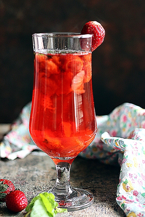 warm strawberry tea served in a tall glass