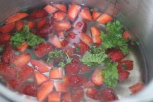 sliced berries and mint leaves added to water
