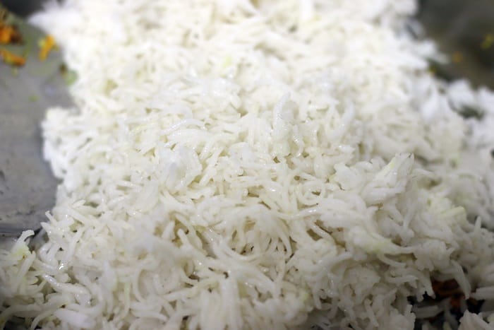 cooked rice added to sautéed turmeric