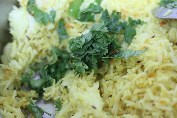 coriander leaves added to turmeric rice.