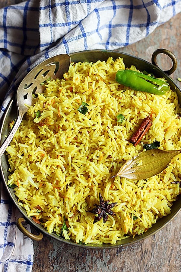 easy turmeric rice recipe in a copper bowl with a spoon