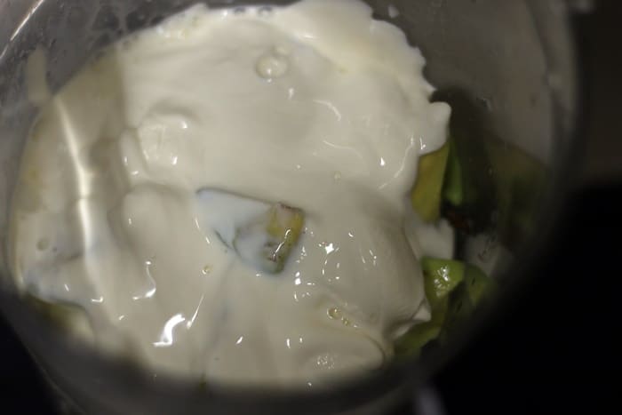 chopped avocado and thick coconut milk in a blender jar for milkshake