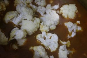 cauliflower florets added to cooked chickpea curry