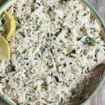 cilantro lime rice served in a green rimmed bowl with a spoon