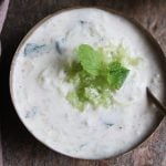 refreshing and creamy cucumber raita served in a copper bowl