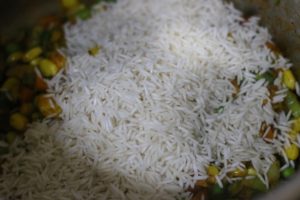 rice added to cooked vegetables for curried rice recipe