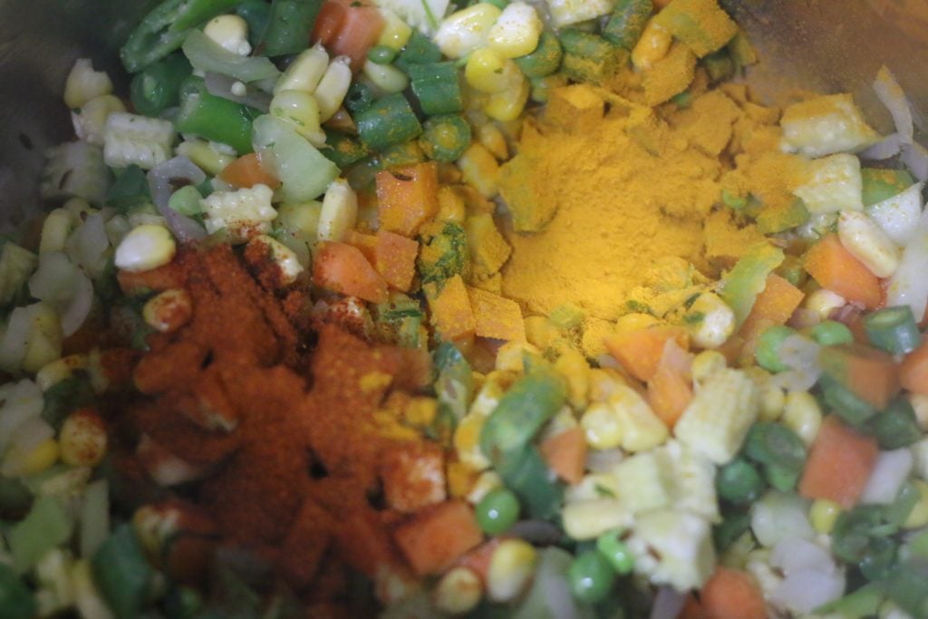 spice powders added to sauteed vegetables