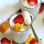 white chocolate mousse topped with fruits and a spoonful of mousse