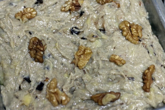 Banana cake batter topped with walnuts