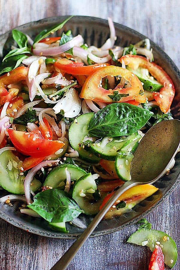 Fresh tomato basil salad served in a brass plate with a spoon