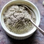 homemade cardamom powder in a small ceramic jar