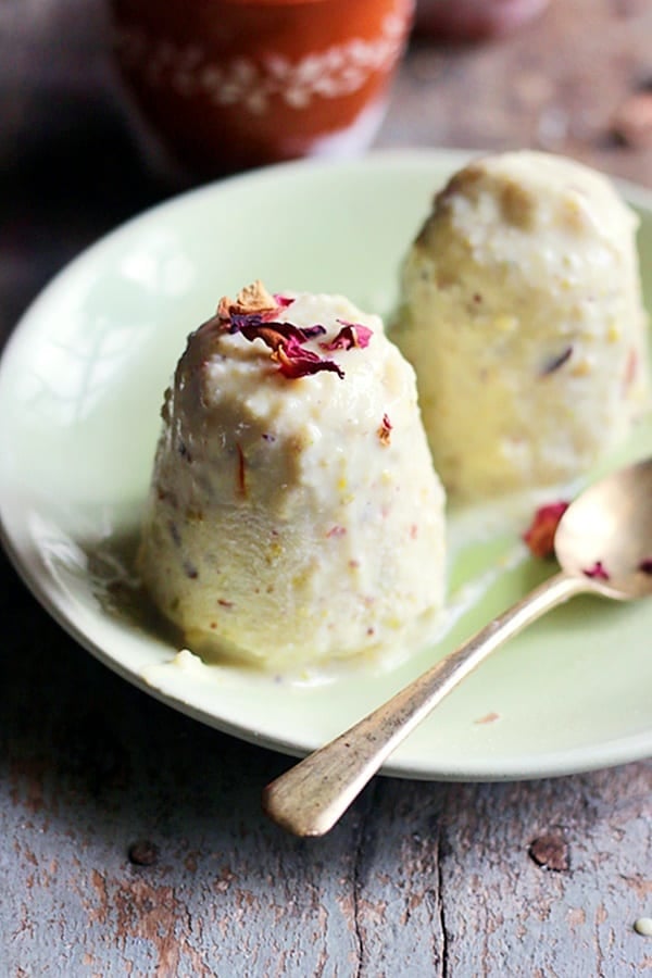 homemade traditional kulfi served in a ceramic plate with a spoon