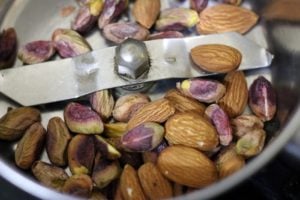 roasted almonds and pistachios in a mixer jar