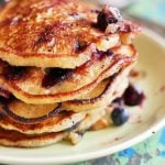 closeup shot of homemade vegan blueberry pancakes served in a ceramic plate