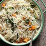 homemade fluffy soft semiya upma served in a enamel rimmed bowl with a spoon