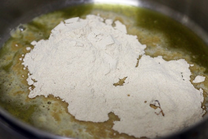whole wheat flour added to hot ghee for roasting