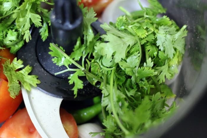 chopping vegetables in food processor for making corn chaat recipe
